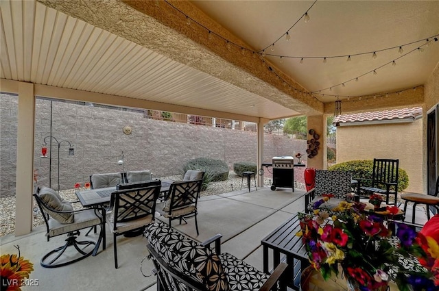 view of patio featuring area for grilling, outdoor dining area, and fence