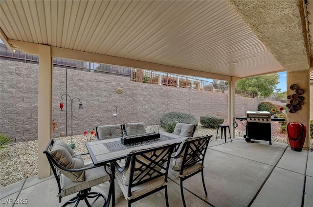 view of patio featuring a fenced backyard, outdoor dining space, and grilling area