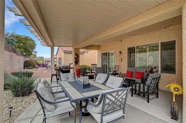 view of patio featuring grilling area, an outdoor living space, outdoor dining area, and fence