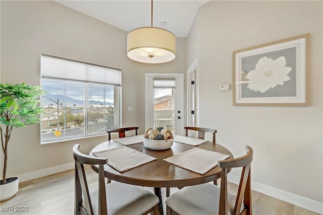 dining room with baseboards and light wood-style floors