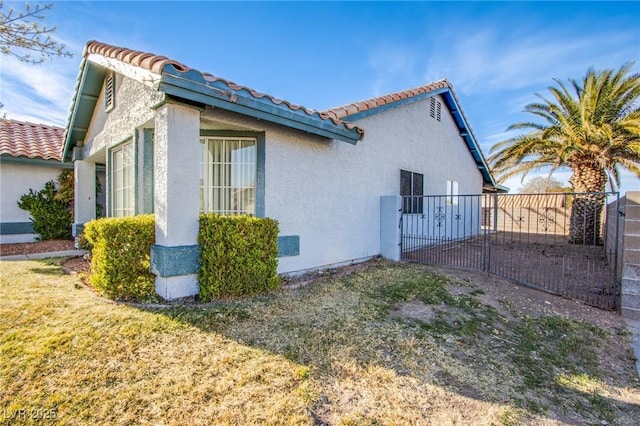 view of side of property featuring fence and stucco siding