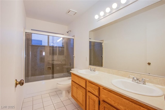 bathroom with a sink, visible vents, toilet, and tile patterned flooring