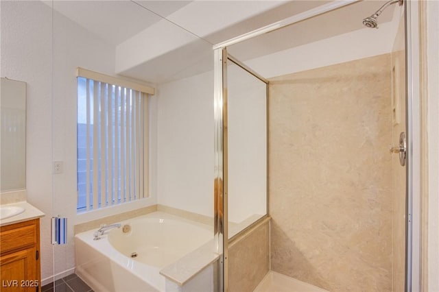 bathroom with a stall shower, vanity, and a bath