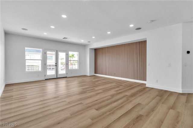 spare room featuring recessed lighting, baseboards, and light wood-style floors