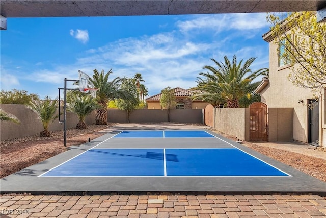 view of basketball court with basketball court, a gate, and fence