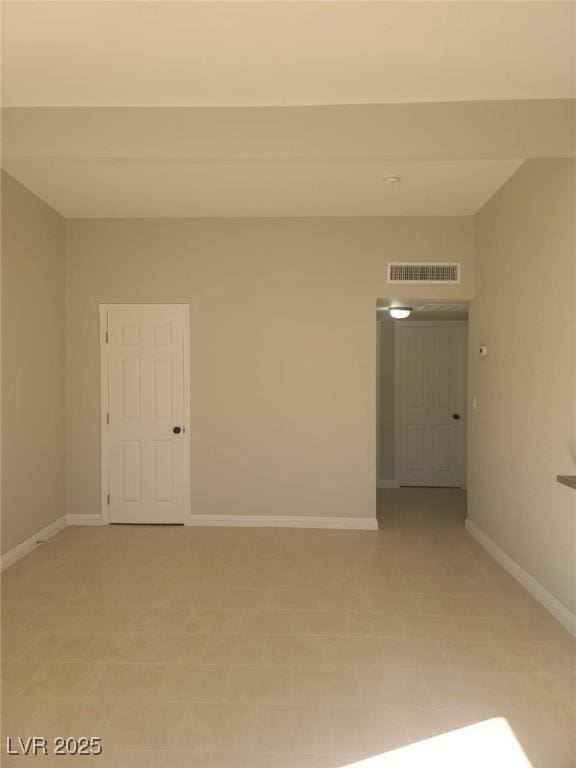 spare room with visible vents and baseboards