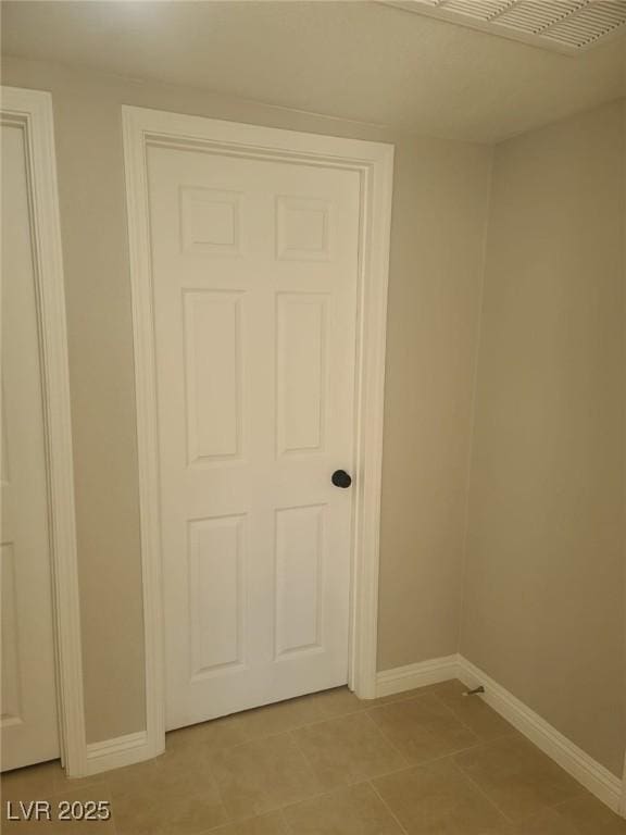 interior space featuring light tile patterned floors and baseboards