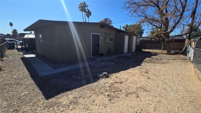 rear view of house featuring fence