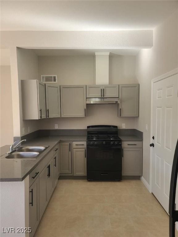 kitchen with black gas stove, gray cabinets, visible vents, and a sink