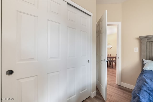 bedroom with baseboards and wood finished floors