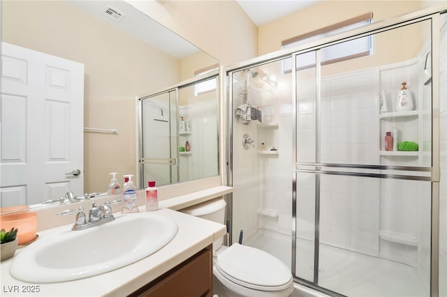 full bathroom with visible vents, a shower stall, toilet, and vanity