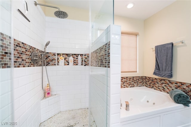 bathroom featuring a tile shower, a tub with jets, and recessed lighting