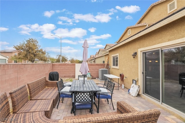 view of patio / terrace with outdoor dining space, cooling unit, and a fenced backyard