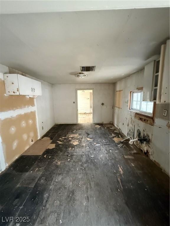 interior space featuring visible vents and white cabinets