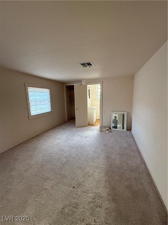 carpeted empty room with visible vents