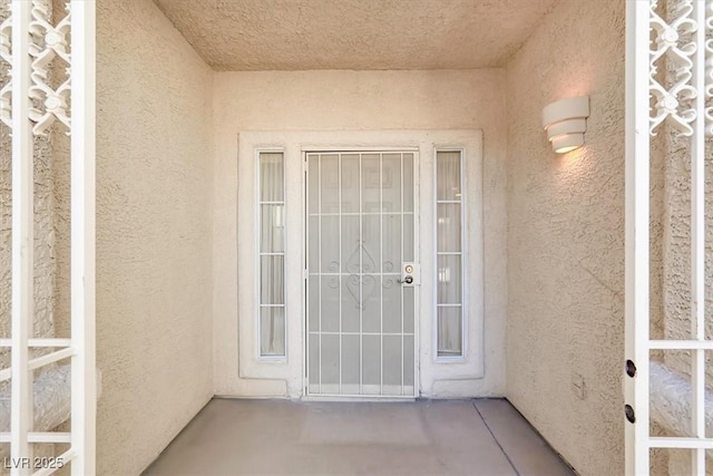 property entrance with stucco siding