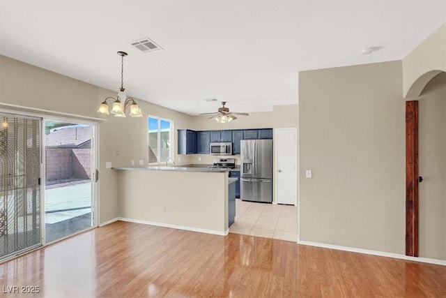 kitchen featuring a wealth of natural light, visible vents, appliances with stainless steel finishes, and a peninsula