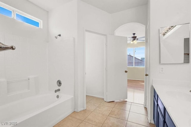 full bath with a wealth of natural light, vanity, a ceiling fan, and tile patterned flooring