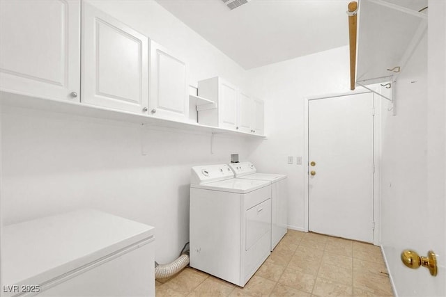 washroom with cabinet space and washer and clothes dryer