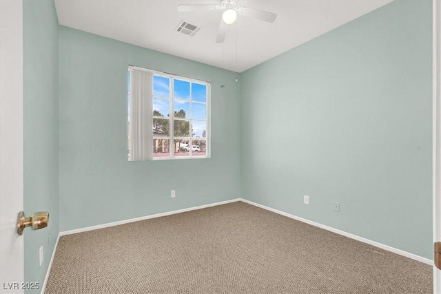 carpeted empty room featuring baseboards, visible vents, and ceiling fan