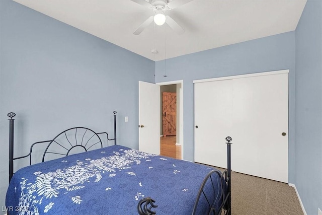 carpeted bedroom featuring a closet and a ceiling fan