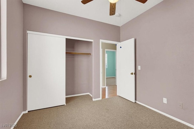 unfurnished bedroom featuring a closet, baseboards, carpet, and a ceiling fan