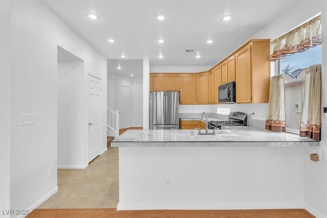 kitchen with light countertops, recessed lighting, appliances with stainless steel finishes, and a sink