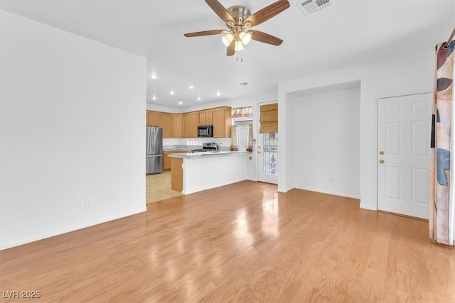 kitchen with visible vents, light wood-style flooring, light countertops, appliances with stainless steel finishes, and open floor plan