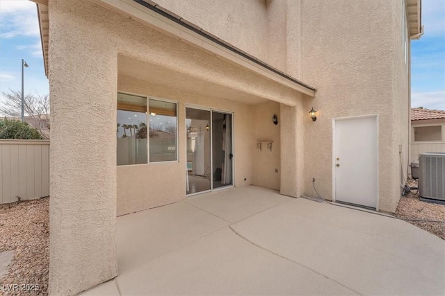 view of patio featuring cooling unit and fence