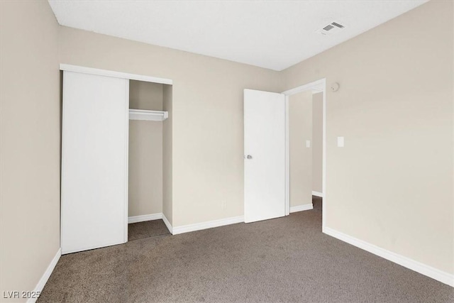 unfurnished bedroom featuring a closet, baseboards, visible vents, and carpet floors