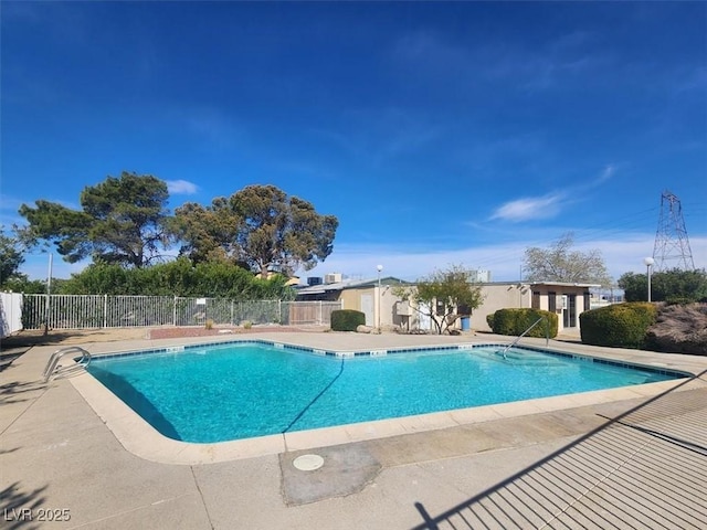 community pool with a patio and fence