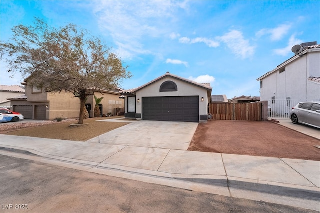 single story home with a gate, fence, stucco siding, concrete driveway, and a garage