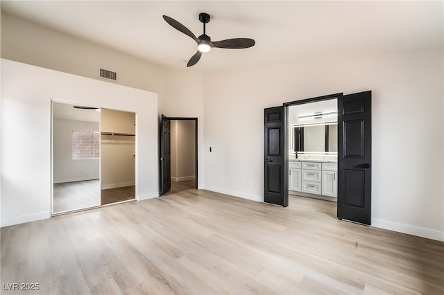 unfurnished bedroom with light wood-style floors, visible vents, and baseboards