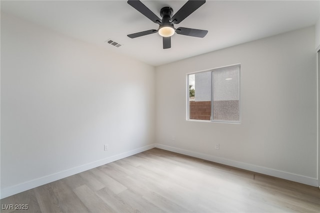 unfurnished room with ceiling fan, light wood-style floors, visible vents, and baseboards