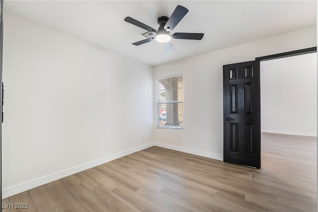 unfurnished room with ceiling fan, baseboards, and wood finished floors