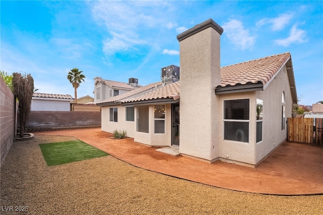 back of property featuring stucco siding, a patio, and a fenced backyard