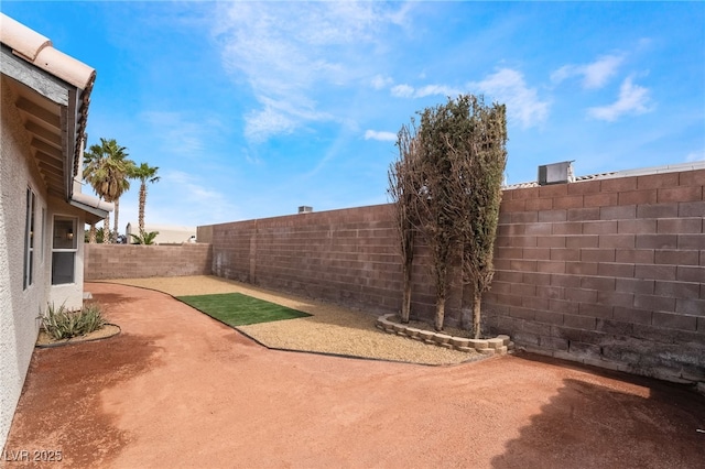 view of yard featuring a patio area and a fenced backyard