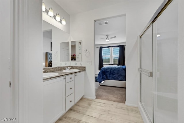 full bath with visible vents, a shower stall, ensuite bath, and a sink