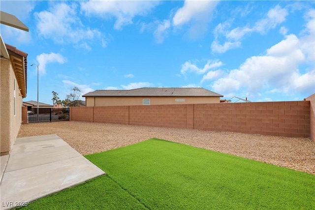 view of yard with a fenced backyard and a patio area