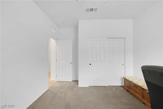 carpeted bedroom featuring visible vents, baseboards, and a closet