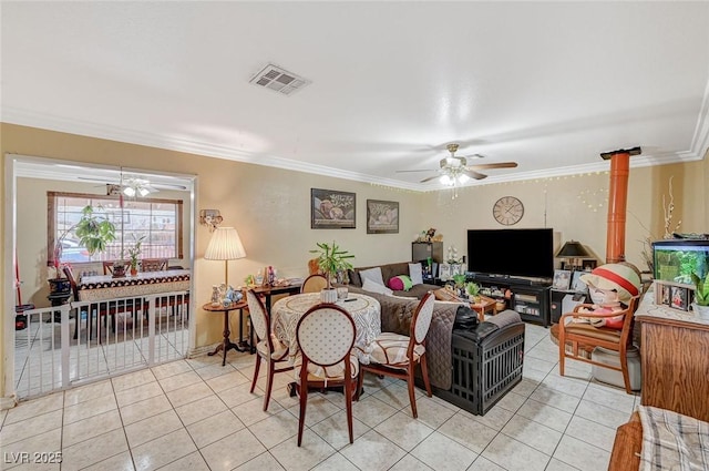 living area featuring crown molding, light tile patterned floors, a ceiling fan, and visible vents