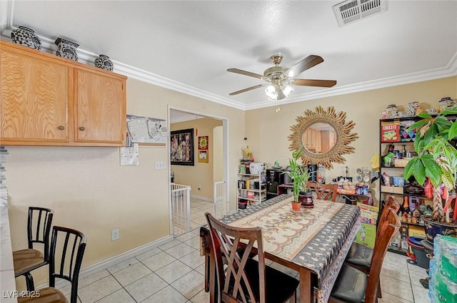 dining room featuring crown molding, light tile patterned floors, and ceiling fan