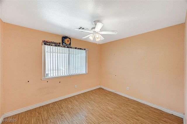 unfurnished room with visible vents, baseboards, a ceiling fan, and light wood finished floors