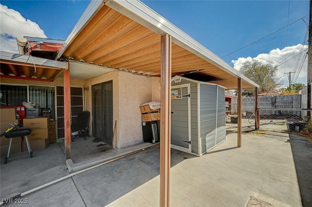 view of patio with an outdoor structure and fence