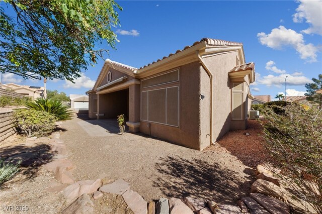 view of home's exterior featuring stucco siding and a tile roof