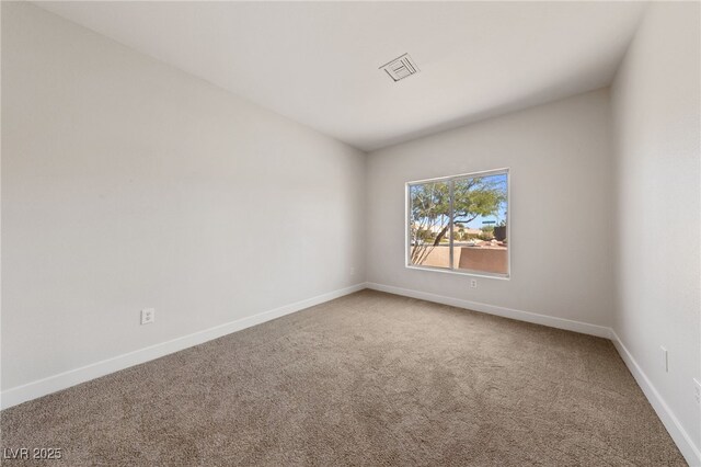 carpeted empty room featuring baseboards and visible vents