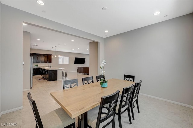 dining space with recessed lighting and baseboards