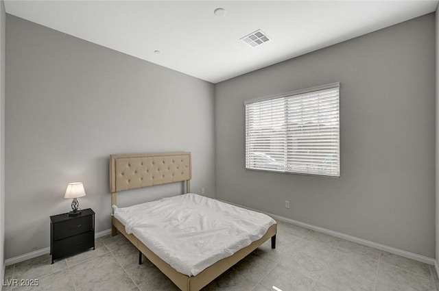 bedroom with light tile patterned floors, visible vents, and baseboards