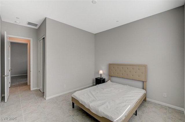 bedroom featuring light tile patterned floors, visible vents, and baseboards