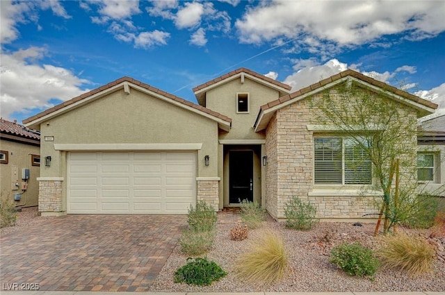 view of front facade featuring decorative driveway, stone siding, an attached garage, and stucco siding